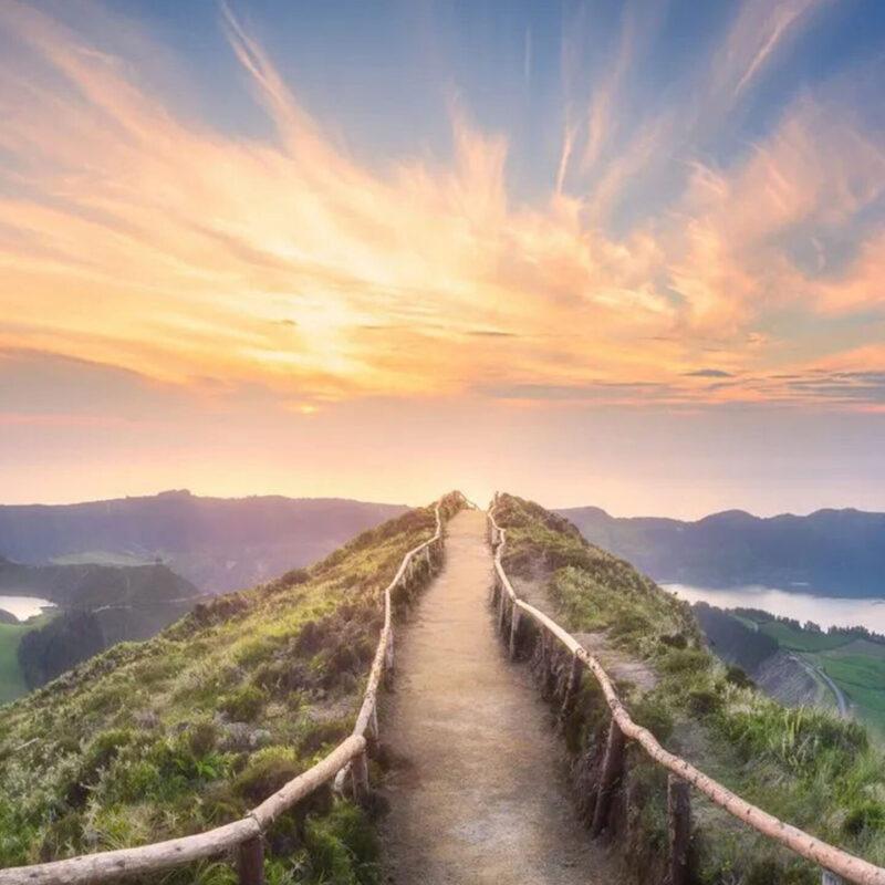 Dirt Path with Wooden Fencing and Rails at Sunrise