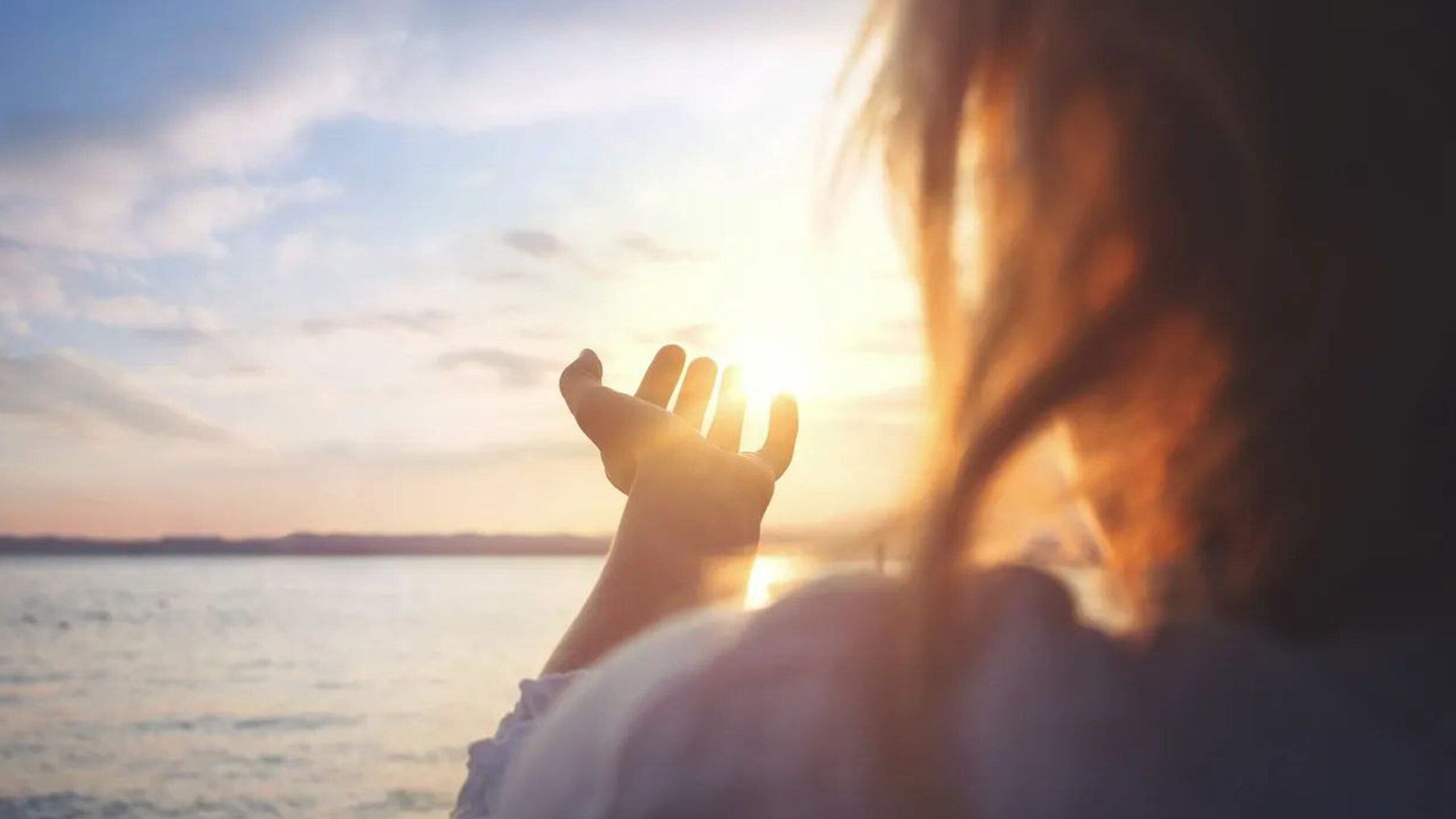 Woman with Hand Holding the Sun