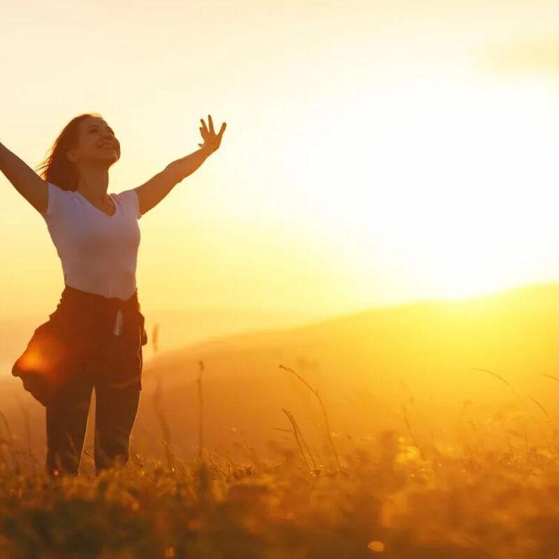 Woman with arms spread wide with a sense of freedom