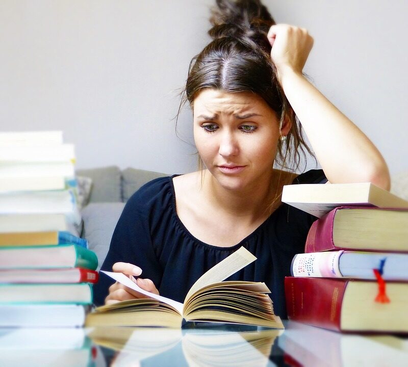 Stressed woman reading a book