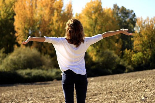 Woman with arms spread wide with a sense of freedom