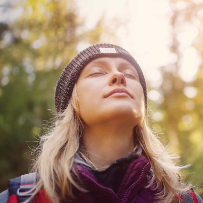 Young woman taking a deep breath