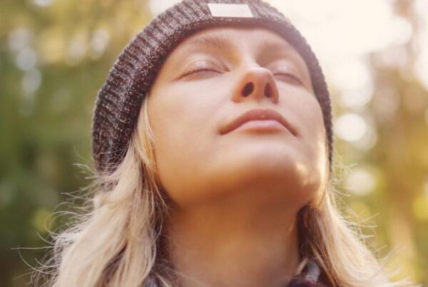 Woman with Eyes Closed Enjoying the Sun on Her Face